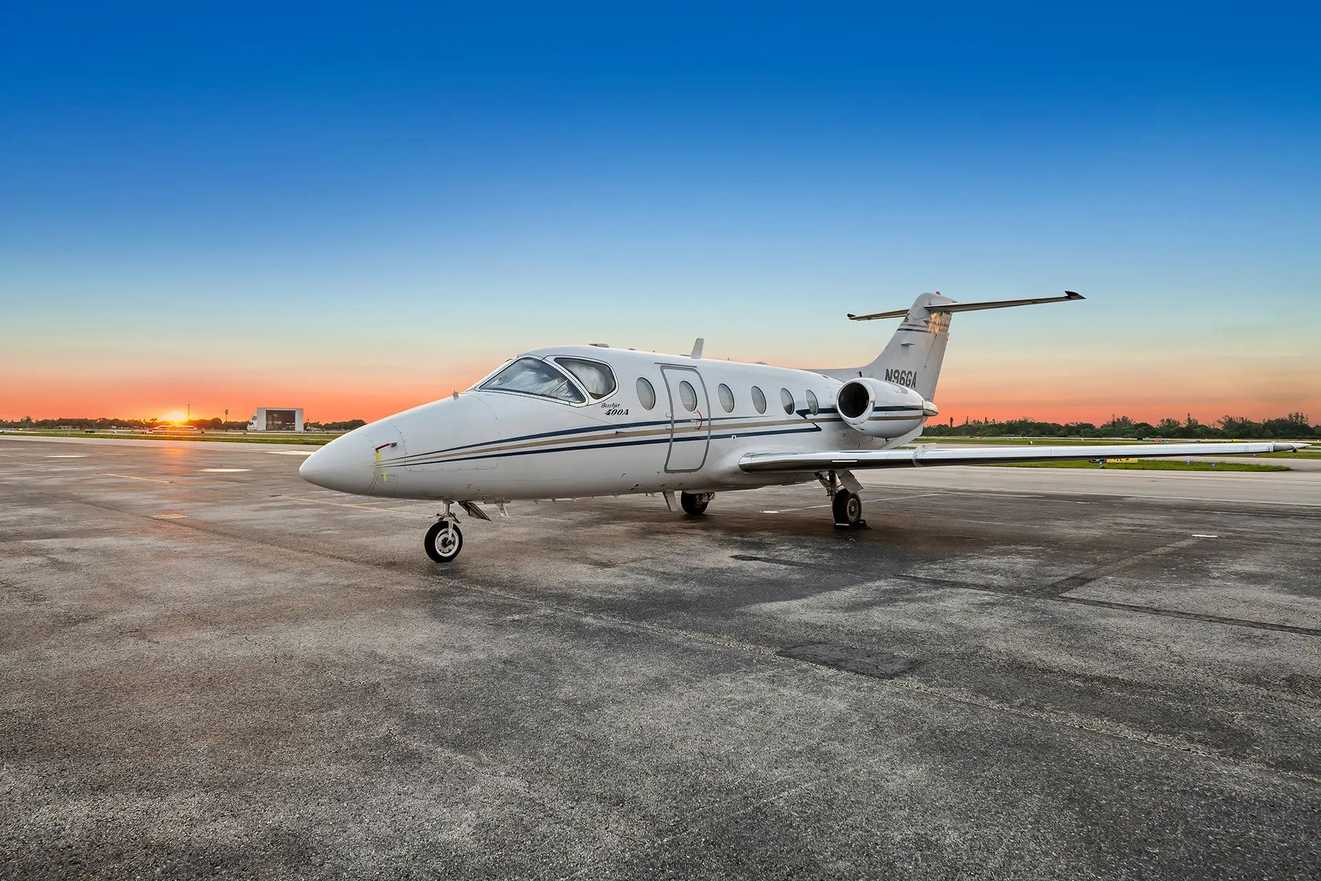 Business jet on ramp at sunset