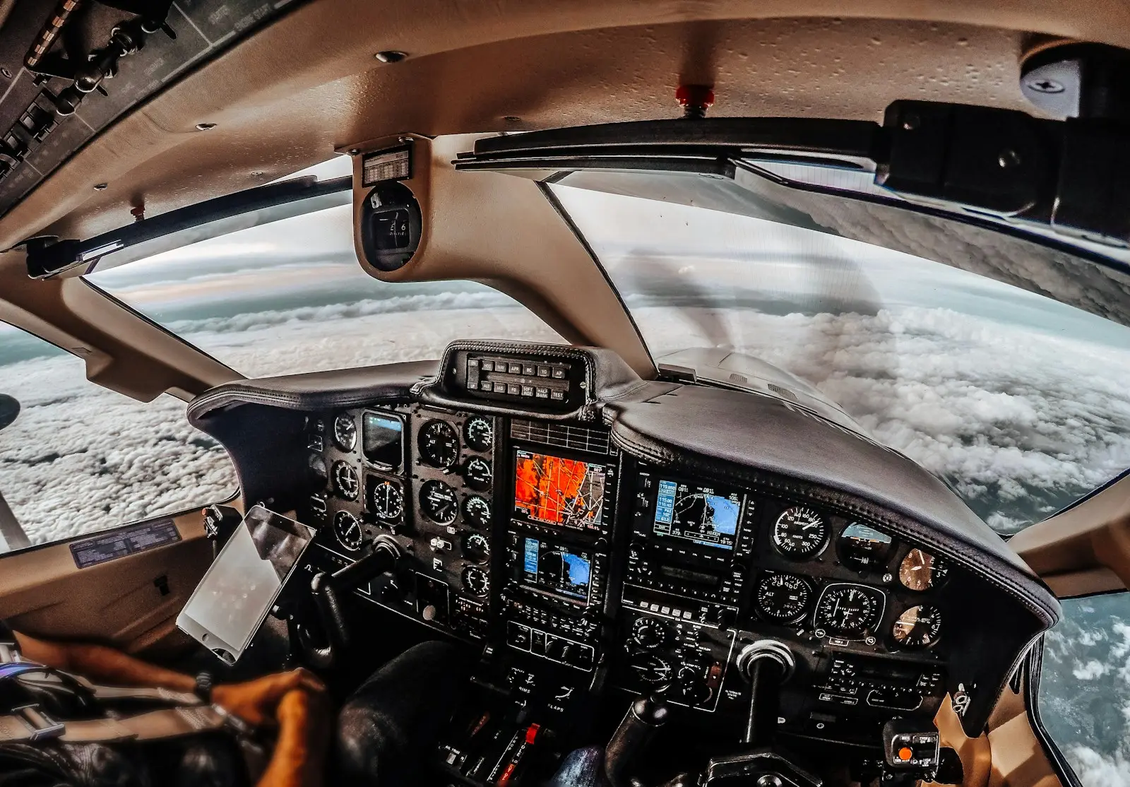 View from a light aircraft cockpit above clouds